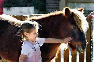 Stroking: Young girl - stroking pony
