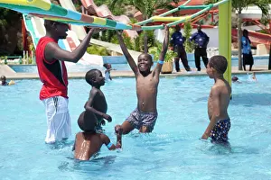 Ladder: Young Kenyan boys playing on suspended ladder in