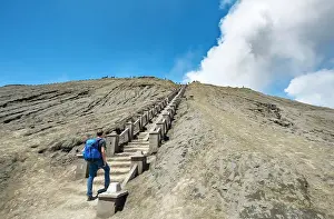 Java: Young man on the stairs to the crater rim of the