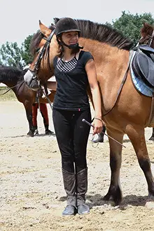 Smiles: Young rider with her Horse in a riding school