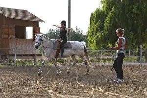 Attach: Young rider performing an aerobatic exercise