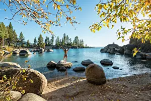 Bikini: Young woman in bikini standing on a round stone