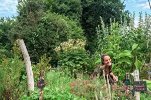 Picket: Young woman in a garden in agroecology