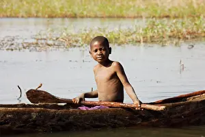 Canoes: Zambia - Tonga boy in a fishing boat at the shore