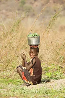 Kariba: Zambia - Tonga girl with vegetables from the vegetable