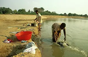Opposite: Zambia - Washing clothes in the Luangwa river just