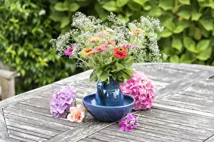 Hydrangea: Zinnias bouquet on a garden table